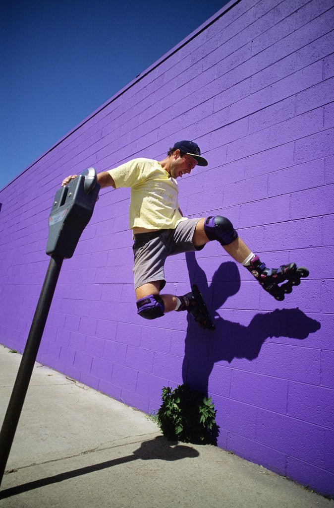 Detail of Boy Wearing Roller Blades Jumping Against Wall by Anonymous