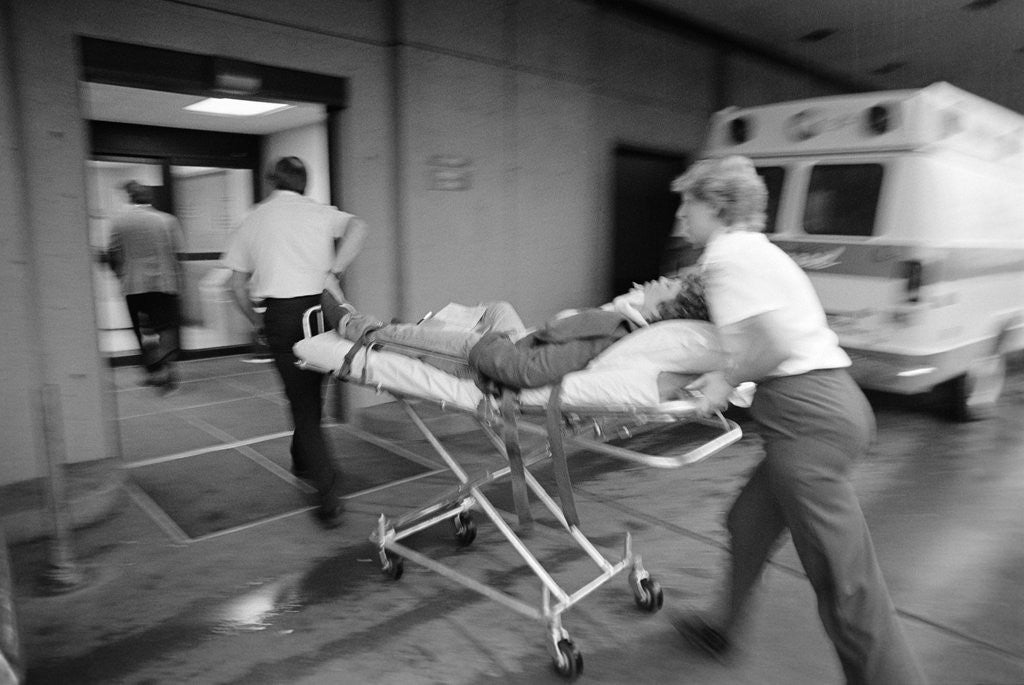 Detail of 1980s EMT team rushing patient into a hospital on a stretcher by Corbis