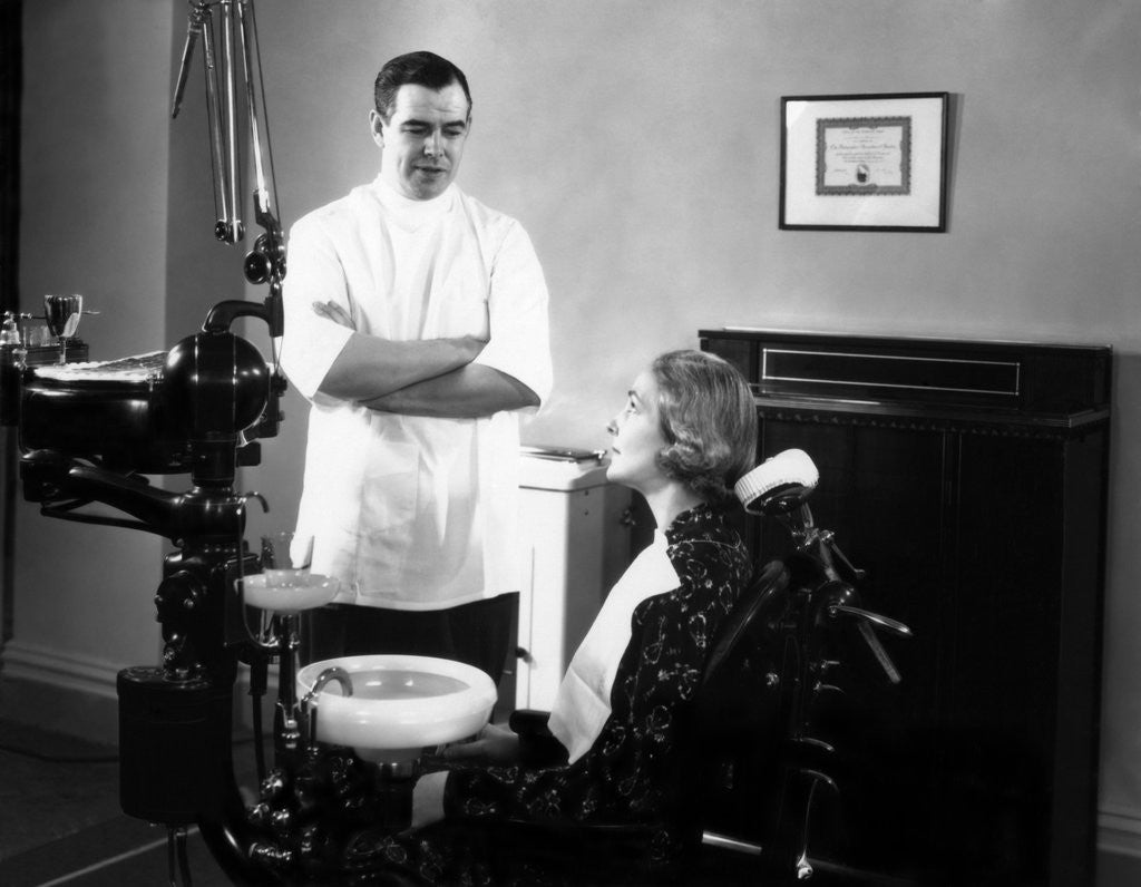 Detail of 1930s 1940s dentist speaking with a female patient by Anonymous
