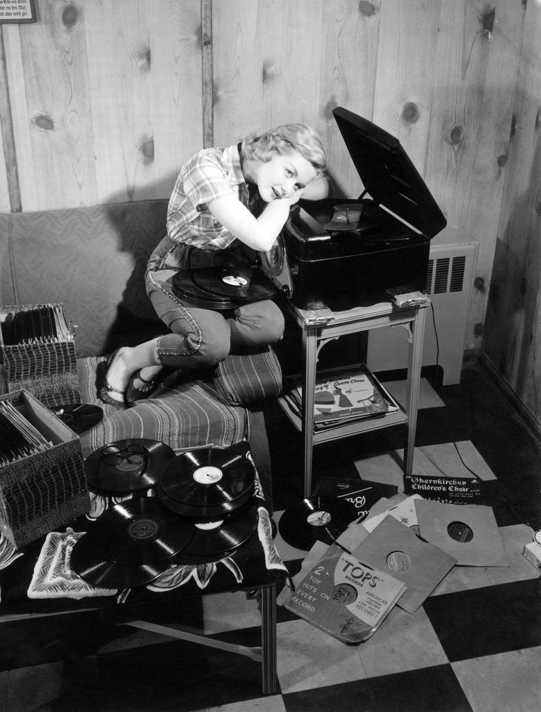 Detail of 1950s teenage girl listening to music on a phonograph by Anonymous