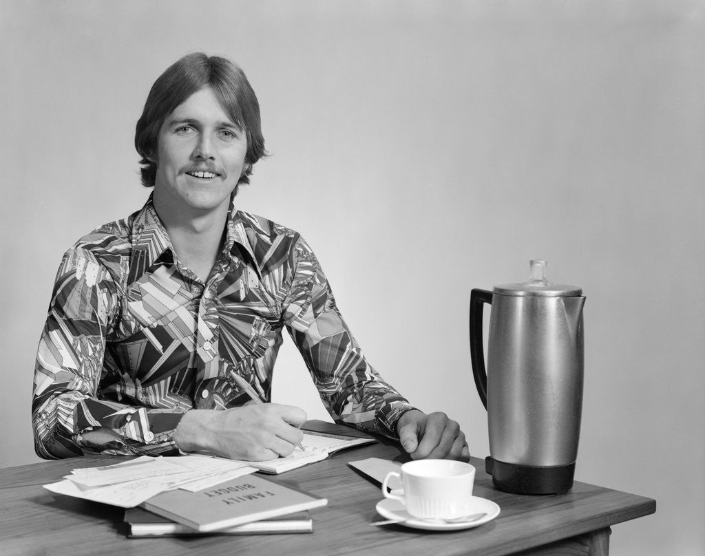 Detail of 1970s smiling young man working on a budget by Anonymous