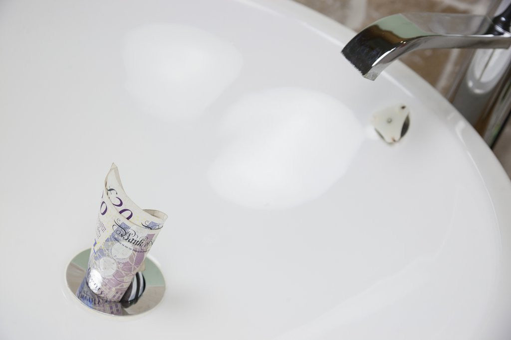Detail of Throwing money down the drain by Corbis