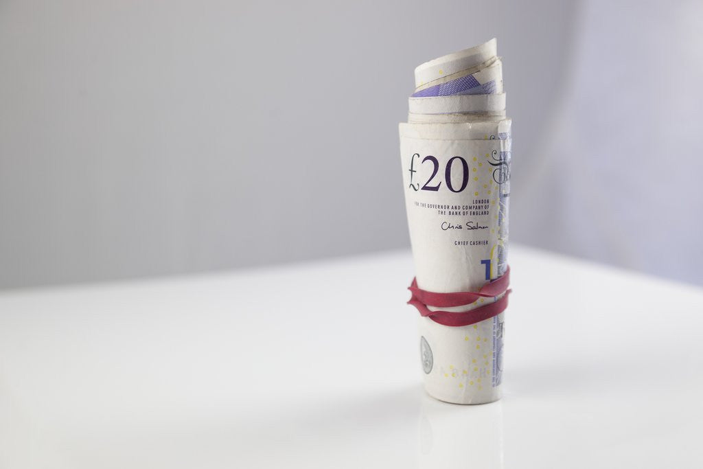 Detail of A roll of twenty pound notes on a table by Anonymous