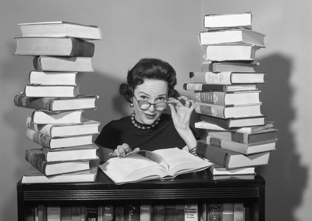 Detail of 1950s portrait of woman sitting with stacks of books by Anonymous