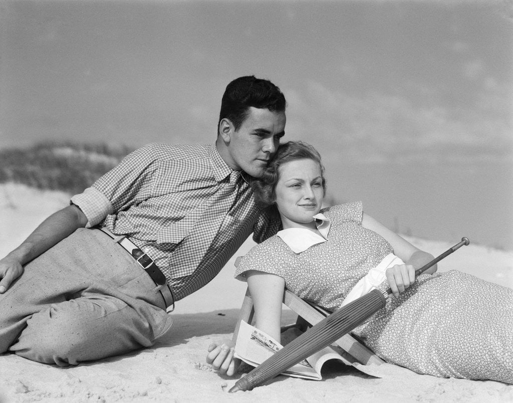 Detail of 1930s couple lying on a beach by Anonymous