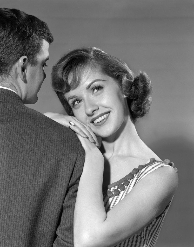 Detail of 1950s woman resting on man's shoulder by Corbis