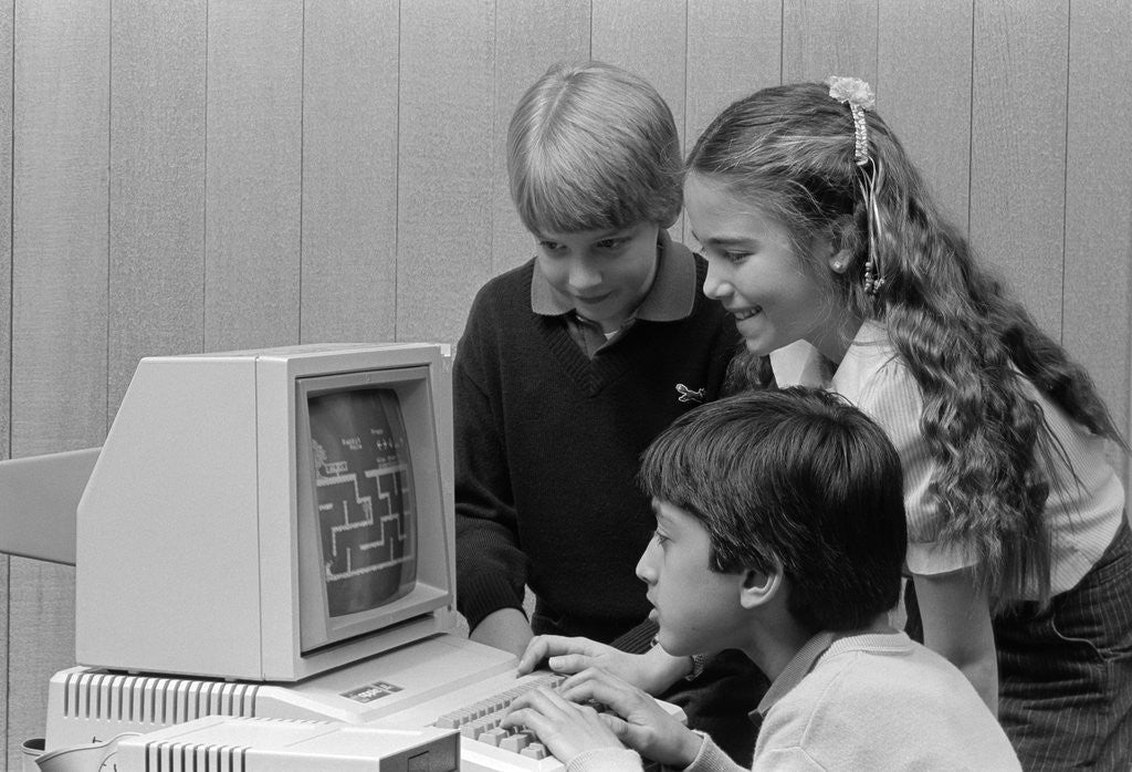 Detail of 1980s boys and girl playing games on a computer by Anonymous