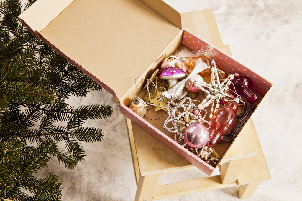 Box with Chistmas ornaments next to Christmas tree, Munich, Bavaria, Germany by Corbis