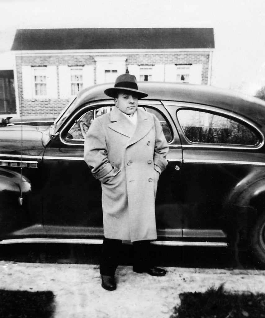 Detail of Mature man stands by his car, ca. 1942. by Anonymous