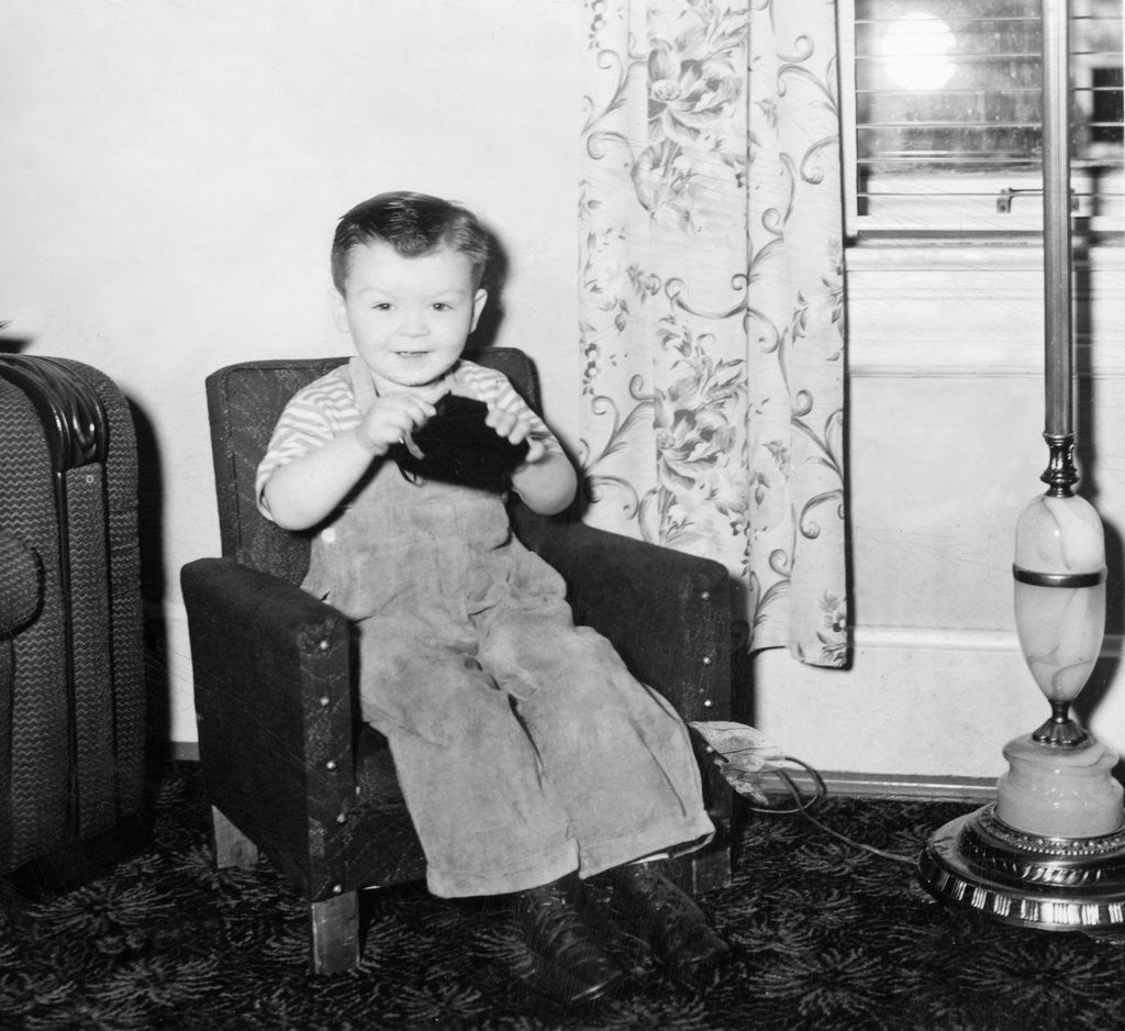 Detail of Young boy in his living room, ca. 1946. by Anonymous