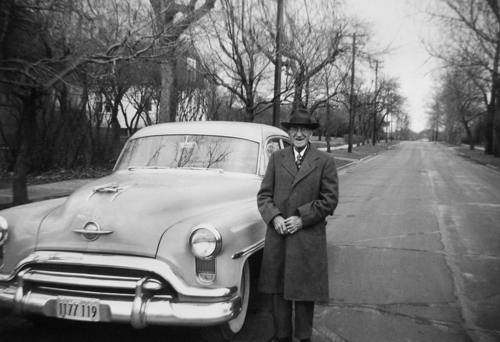 Detail of Senior man with his automobile on an Illinois street, ca. 1950. by Anonymous