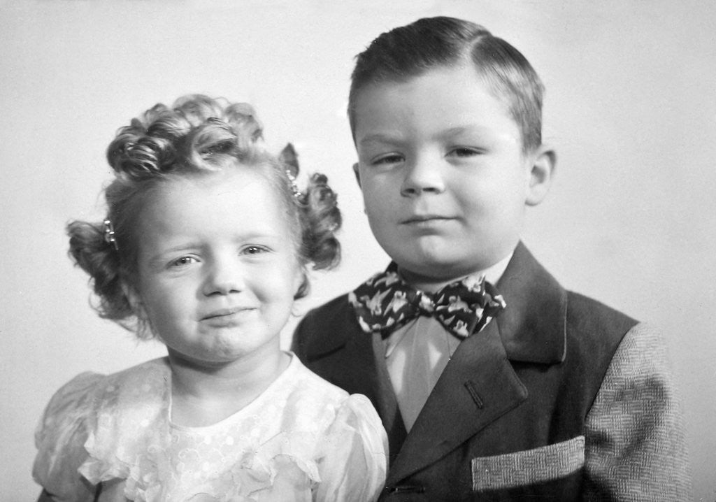 Brother and sister studio portrait, ca. 1949. by Corbis