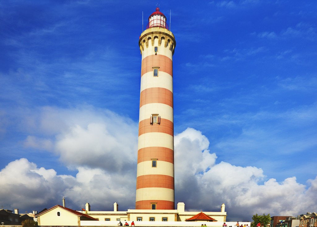 Detail of Barra Lighthouse, Costa Nova, Aveiro with large clouds by Corbis