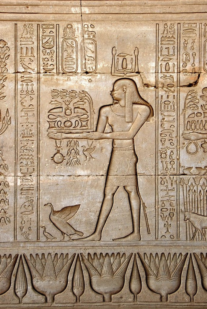 Detail of Ancient Egyptian sunken relief depicting man carrying offerings to the goddess Hathor by Corbis