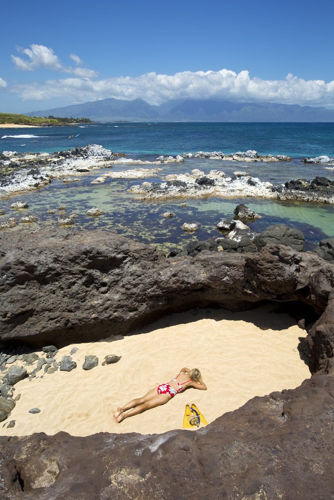 Detail of Woman sunbathing in secluded area of sand, Ho'okipa Beach Park, Maui, Hawaii MR by Corbis