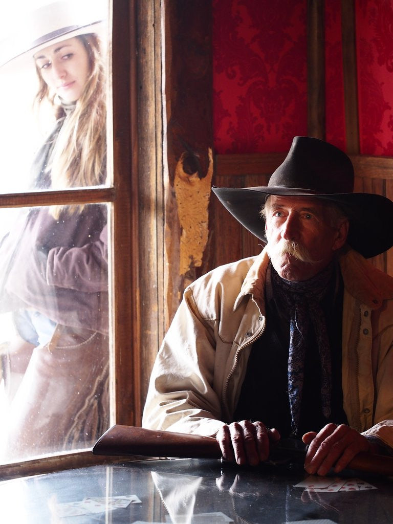 Detail of Cowboy with rifle and Cowgirl looking over his shoulder by Anonymous