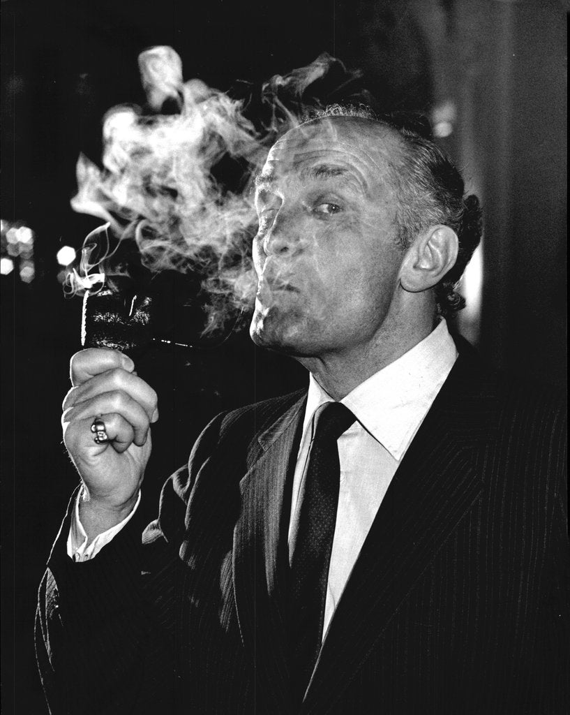 Detail of Boxer Henry Cooper smoking a pipe by Associated Newspapers