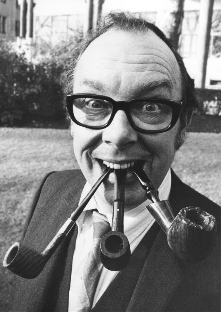 Detail of Eric Morecambe  with three pipes in his mouth by Associated Newspapers