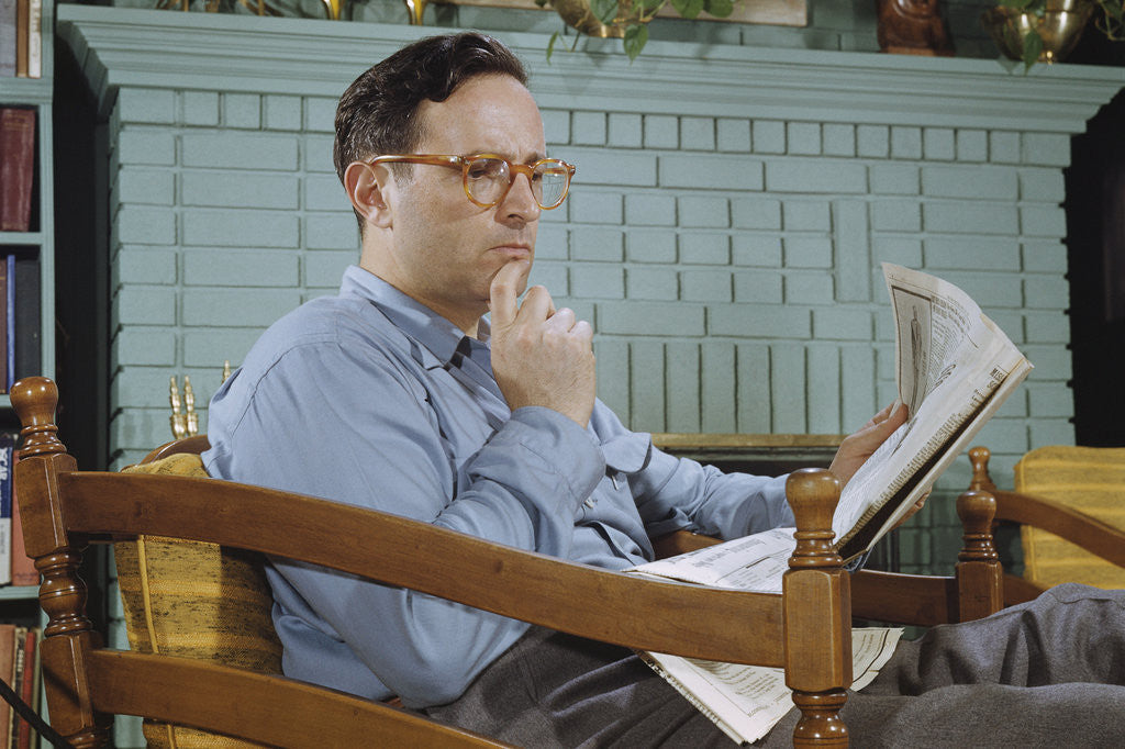 Detail of Pensive Man Reading Newspaper in Living Room by Anonymous