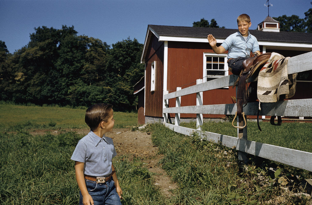 Detail of Boy Sitting on Fence Waving to Friend by Anonymous