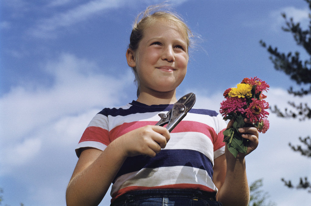 Detail of Girl Holding Cut Flowers by Corbis