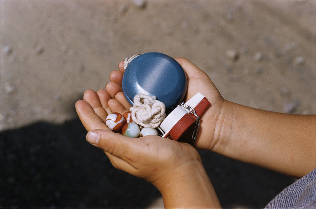 Detail of Child Holding Toys by Corbis