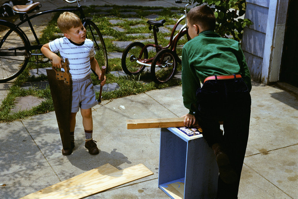Detail of Brothers Working on a Project by Corbis