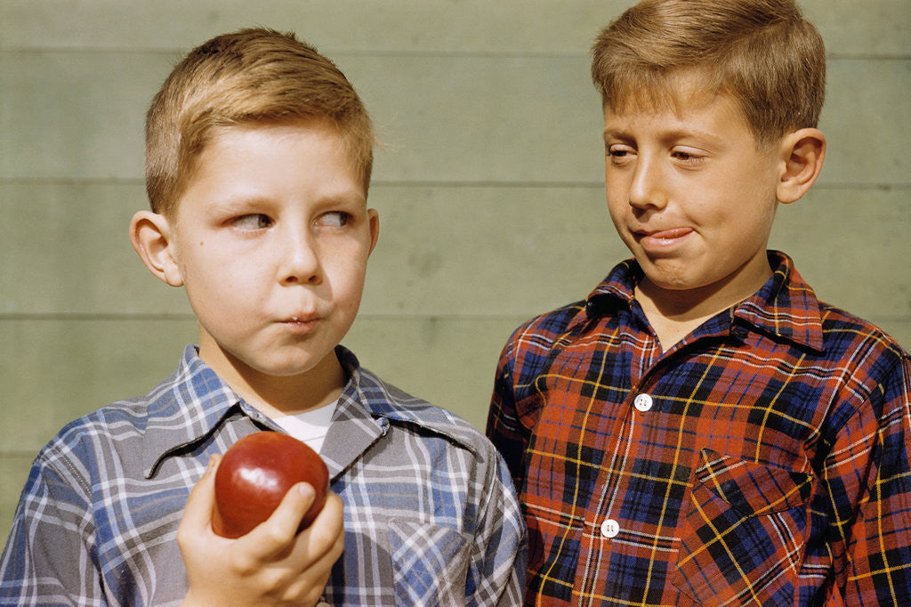 Detail of Boy Eying His Brother's Apple by Corbis