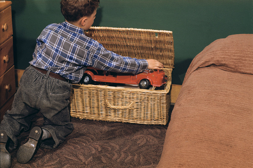 Detail of Boy Removing Fire Engine from Toy Chest by Anonymous