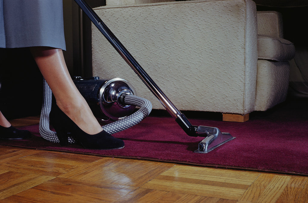 Detail of Woman Vacuuming Rug by Anonymous