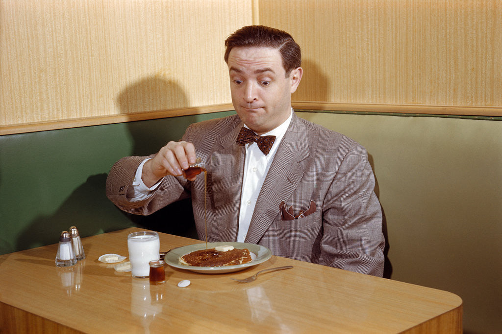 Detail of Businessman Pouring Syrup on Pancakes by Corbis