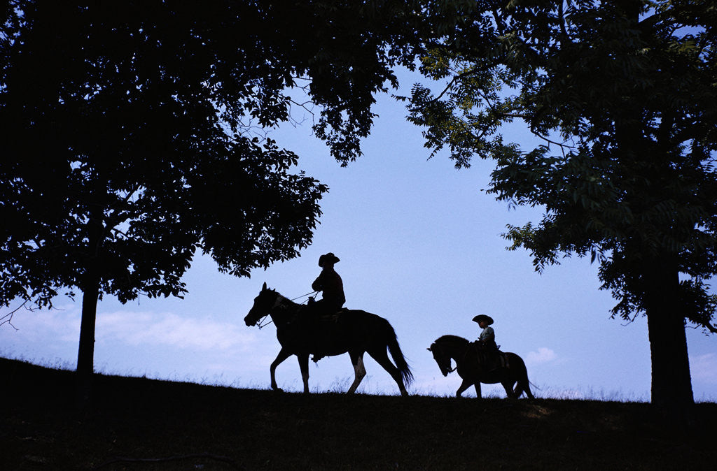 Detail of Father and Son Riding Horses by Corbis