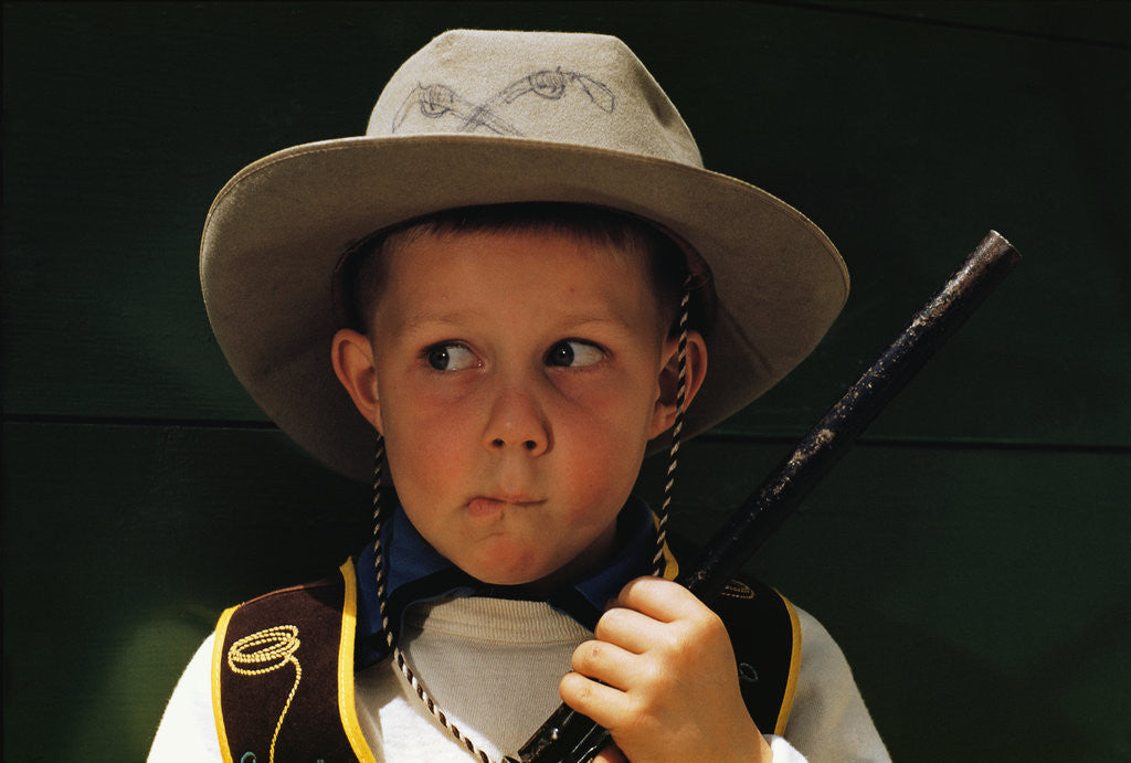 Detail of Boy Playing Cowboy with Gun by Corbis