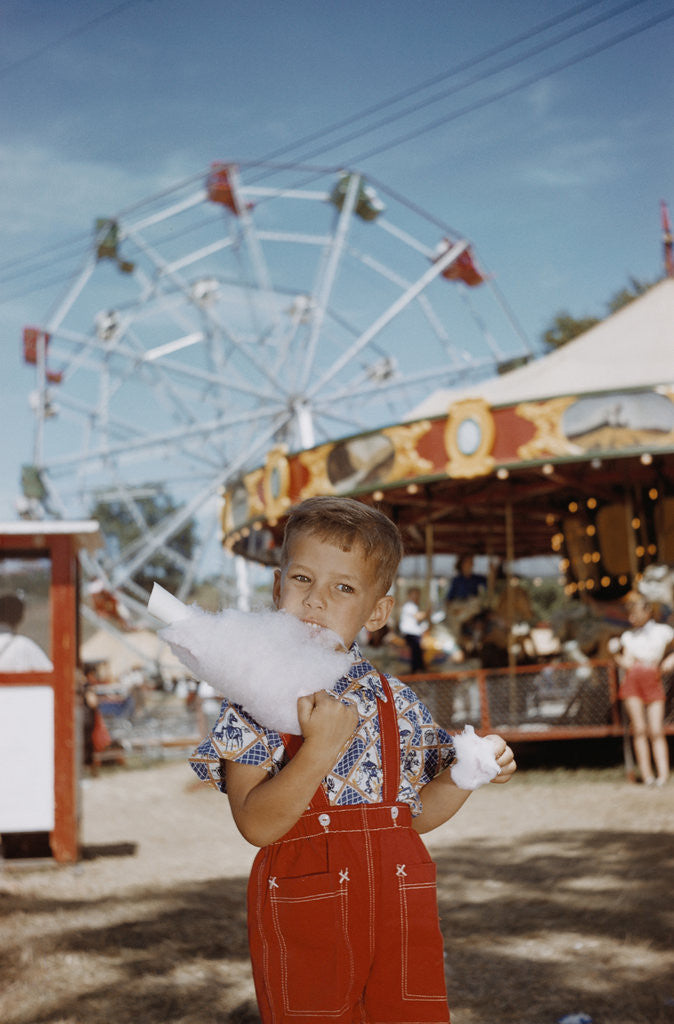 Detail of Boy Eating Cotton Candy at Fair by Corbis