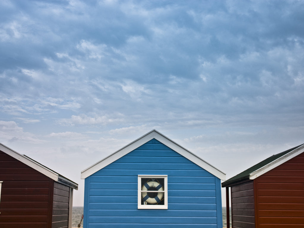 Detail of Beach huts in a row against sky by Assaf Frank