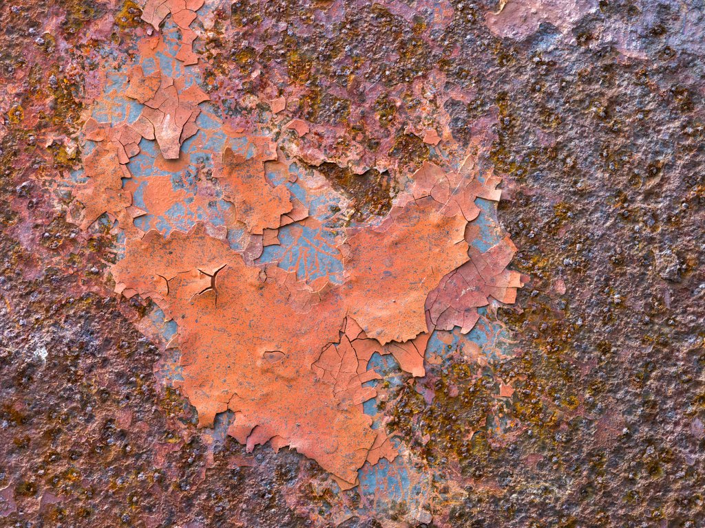 Detail of Rusty paint on old door by Assaf Frank