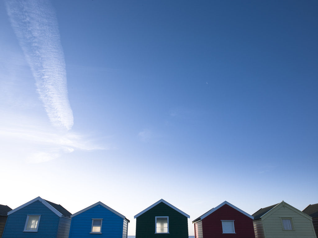 Detail of Beach huts in a row against blue skies by Assaf Frank
