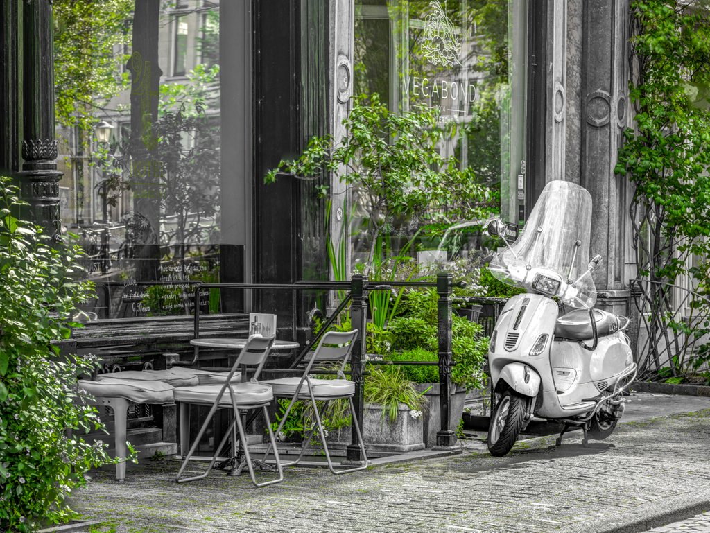 Detail of Scooter parked by street cafe by Assaf Frank