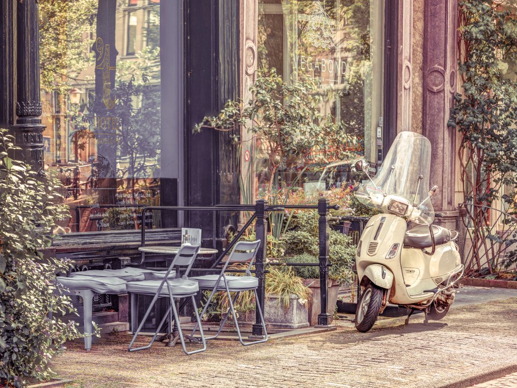 Detail of Scooter parked by street cafe by Assaf Frank