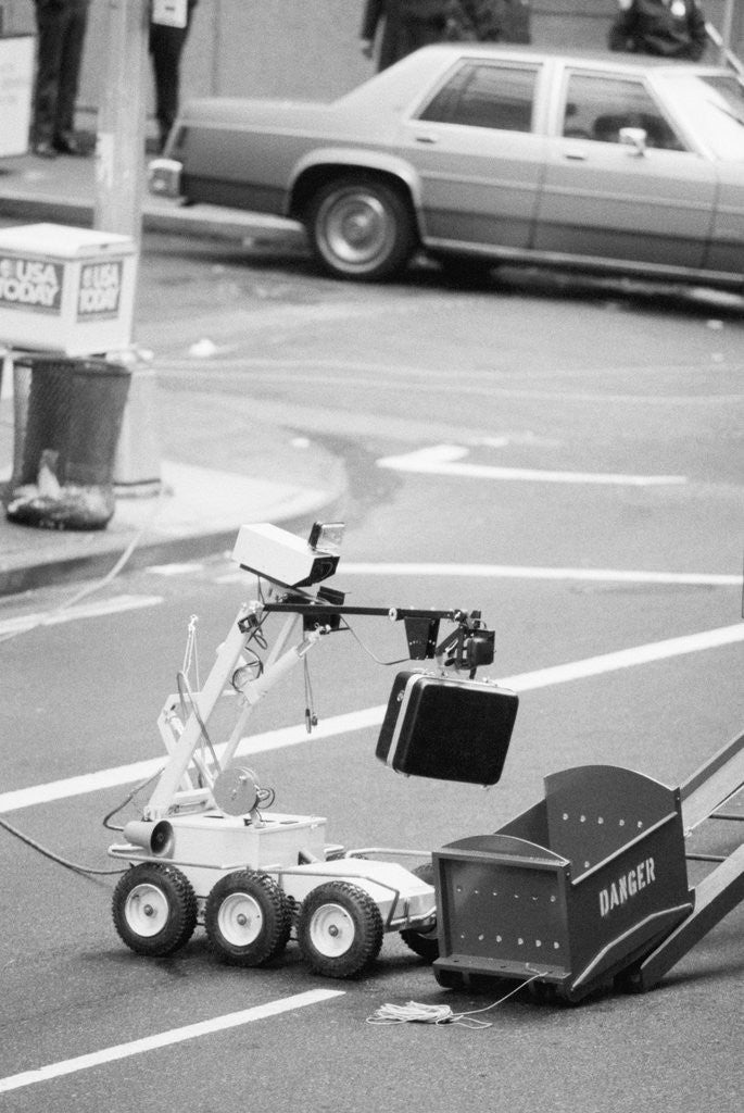 Detail of Police Robot Disposing of Suspicious Briefcase by Anonymous