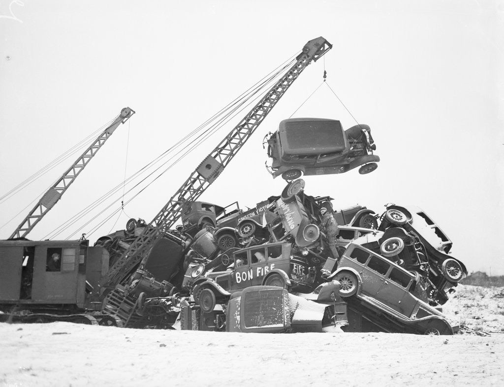 Detail of Crane Stacking Up Old Cars to be Burned in a Bonfire by Anonymous