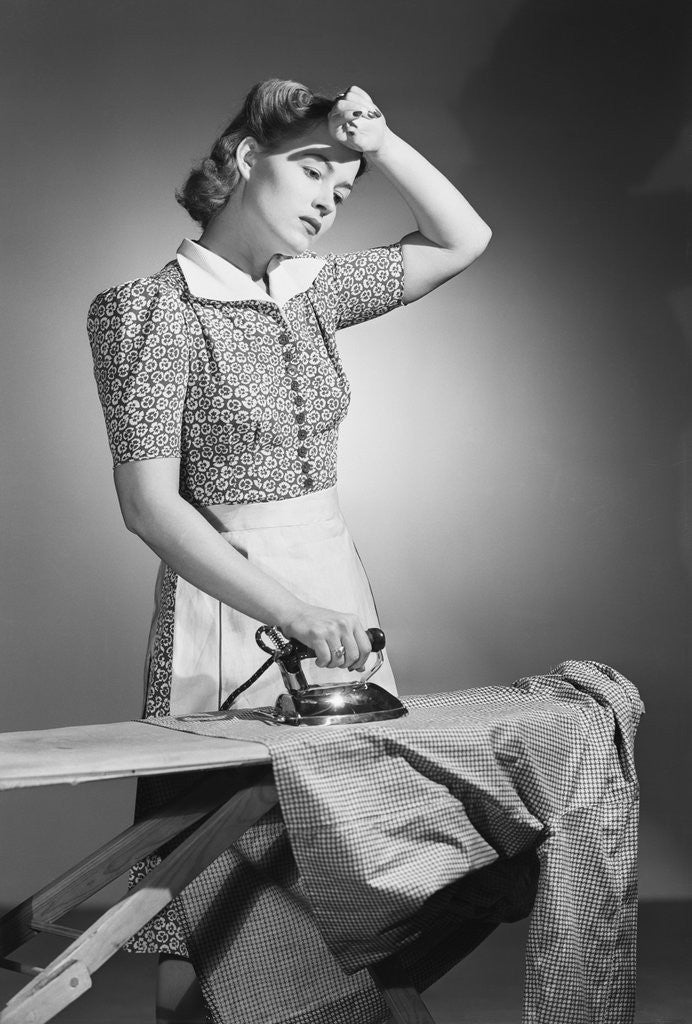 Detail of Woman Hard at Work Ironing by Corbis