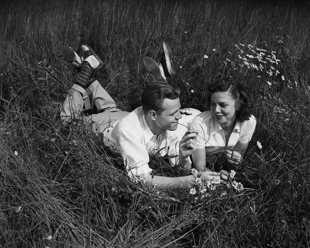 Detail of Young Couple Lying in the Grass by Corbis