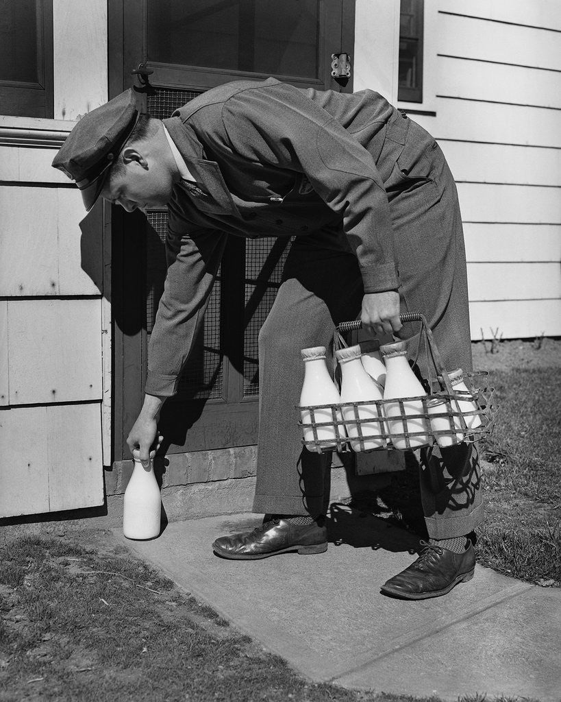 Detail of Milkman Leaving Milk Bottle on Doorstep by Corbis
