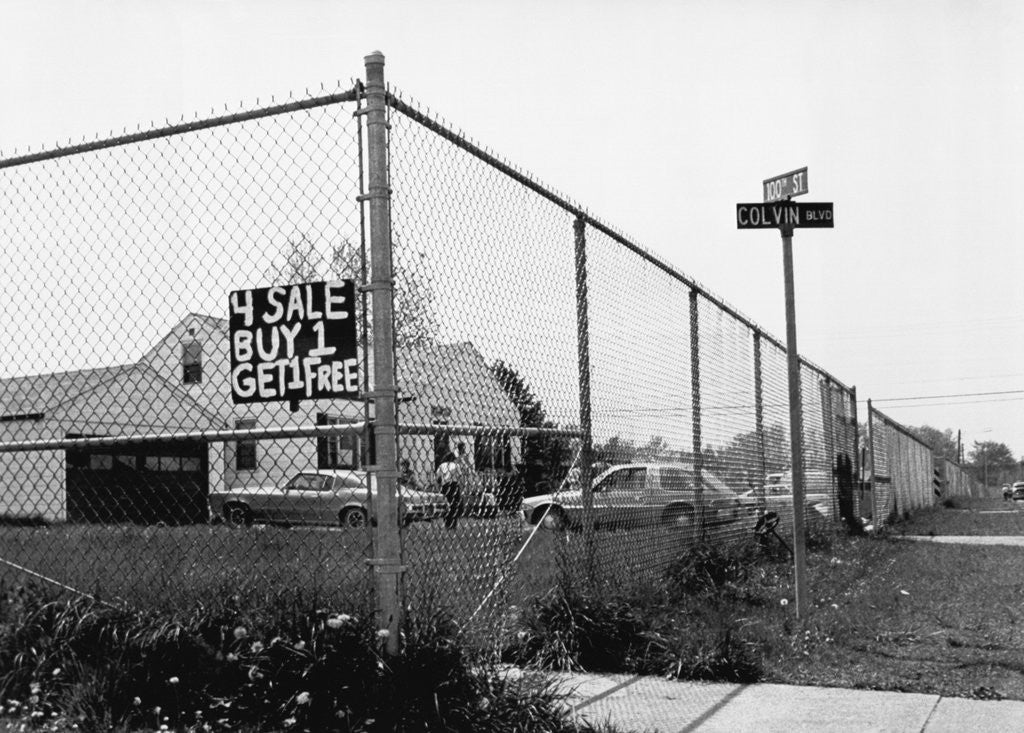 Detail of Buy 1 Get 1 Free Real Estate Sign by Anonymous