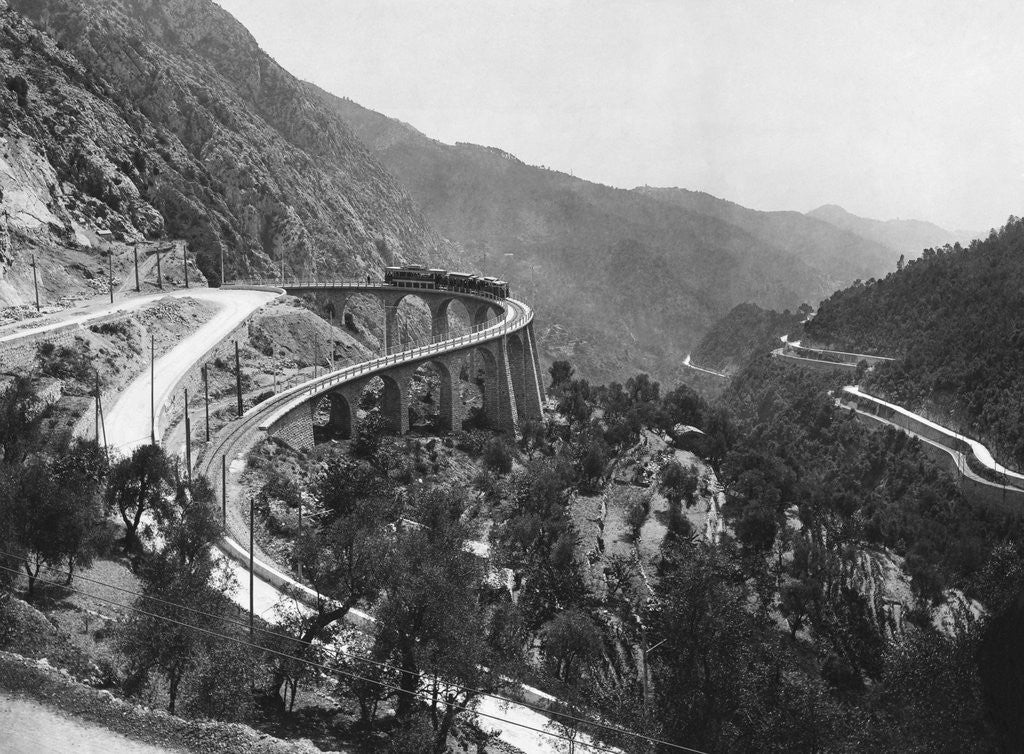 Detail of Train Traveling Over Viaduct in Mountain by Anonymous