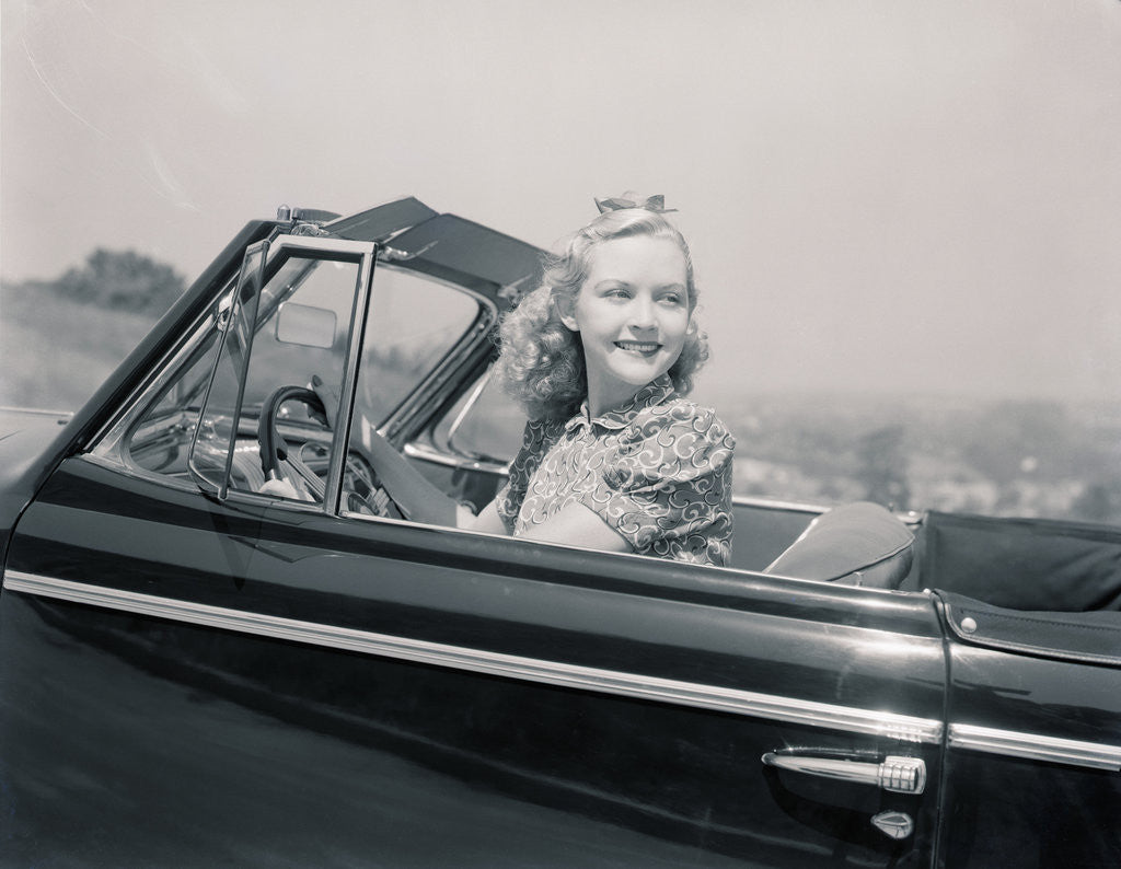 Detail of Blonde Woman Driving a Convertible by Corbis