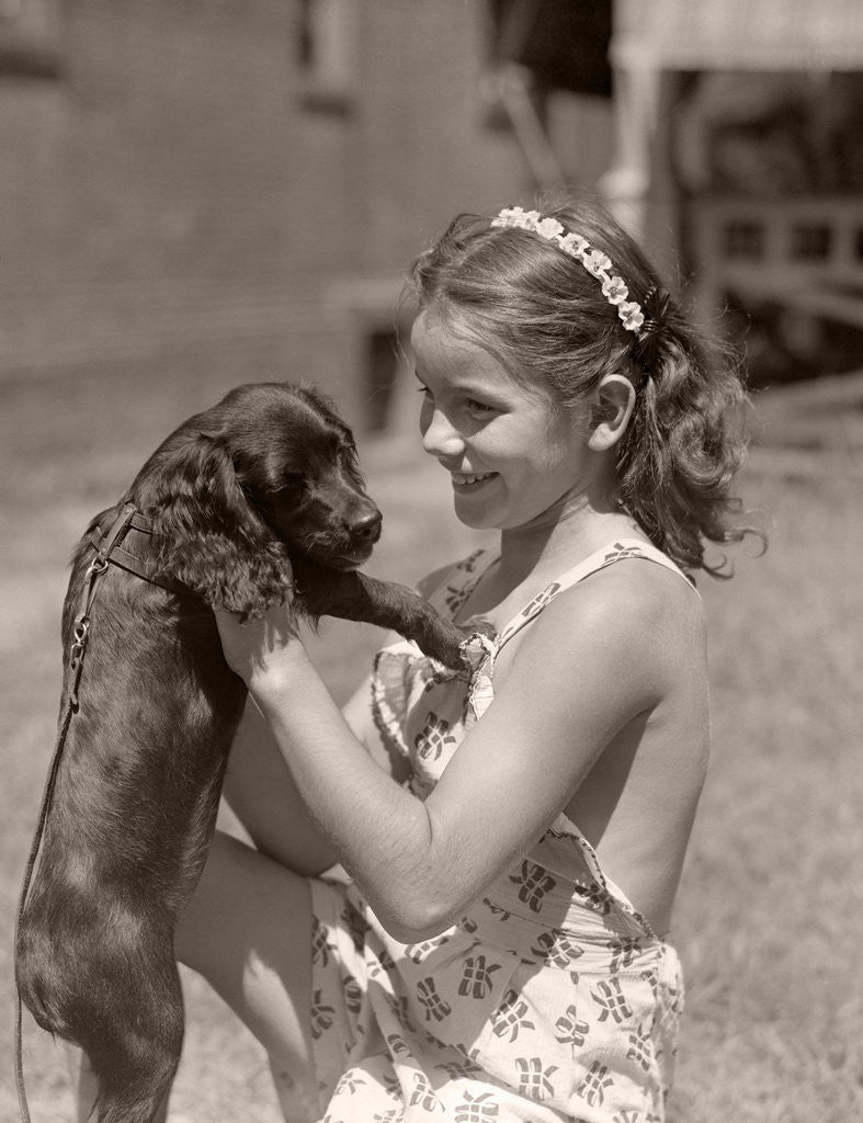 Detail of Girl Holding Puppy by Corbis