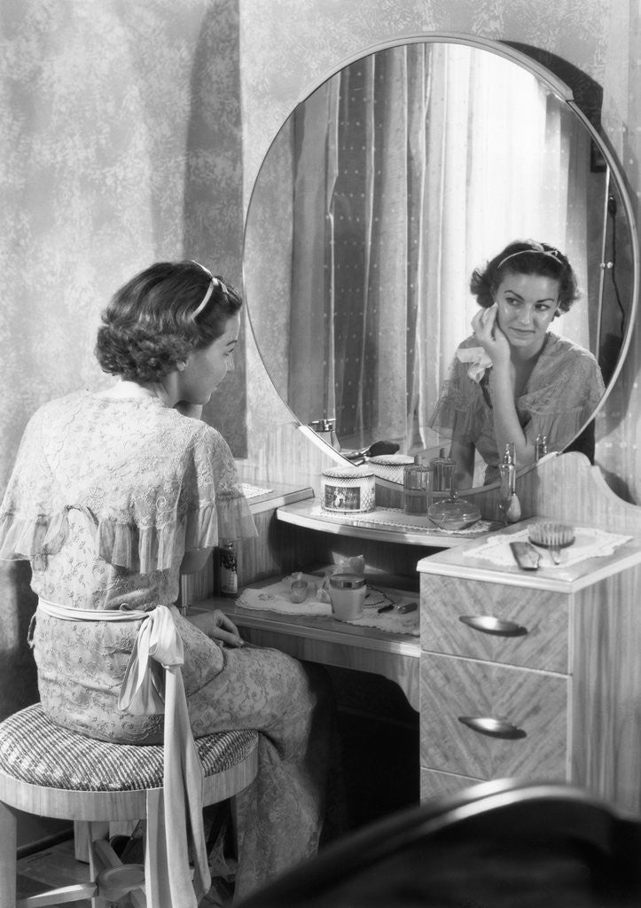 Detail of Young Woman Applying Face Cream at Vanity by Anonymous