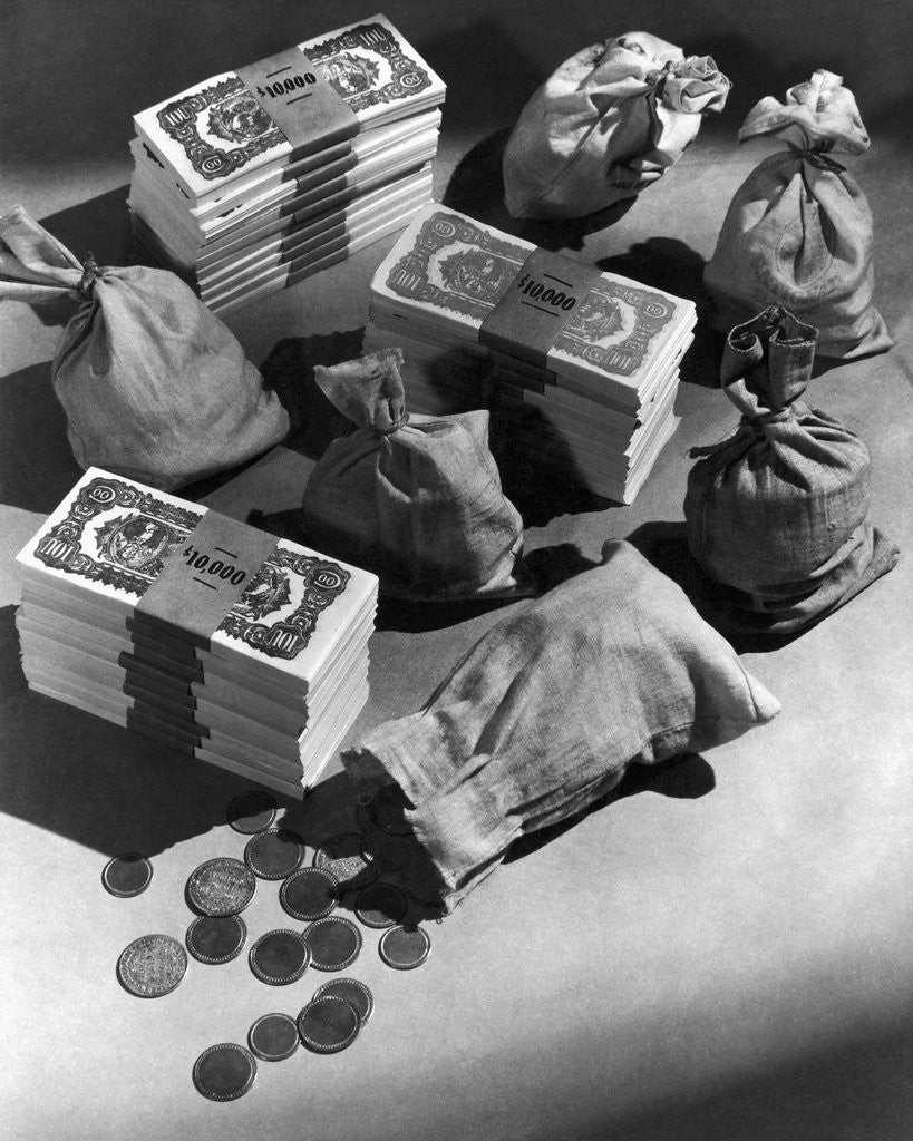 Detail of Stacks of $100 Bills, Coins, and Money Bags by Corbis